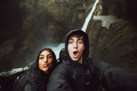 Maddie and Malakai pulling faces in a selfie at the waterfall