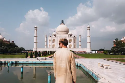Malakai standing at the long pool in front of the Taj Mahal