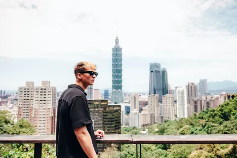 Malakai on a viewpoint above a city of towers