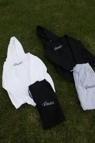 Detached Apparel hoodies and sweatpants laid out on grass