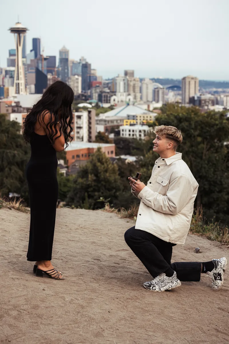 Malakai proposing to Maddie on a viewpoint above Seattle