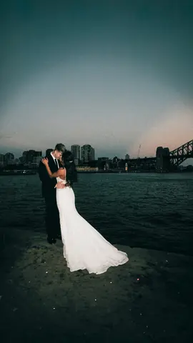 The two of them on the harbour at dusk with the bridge in the distance